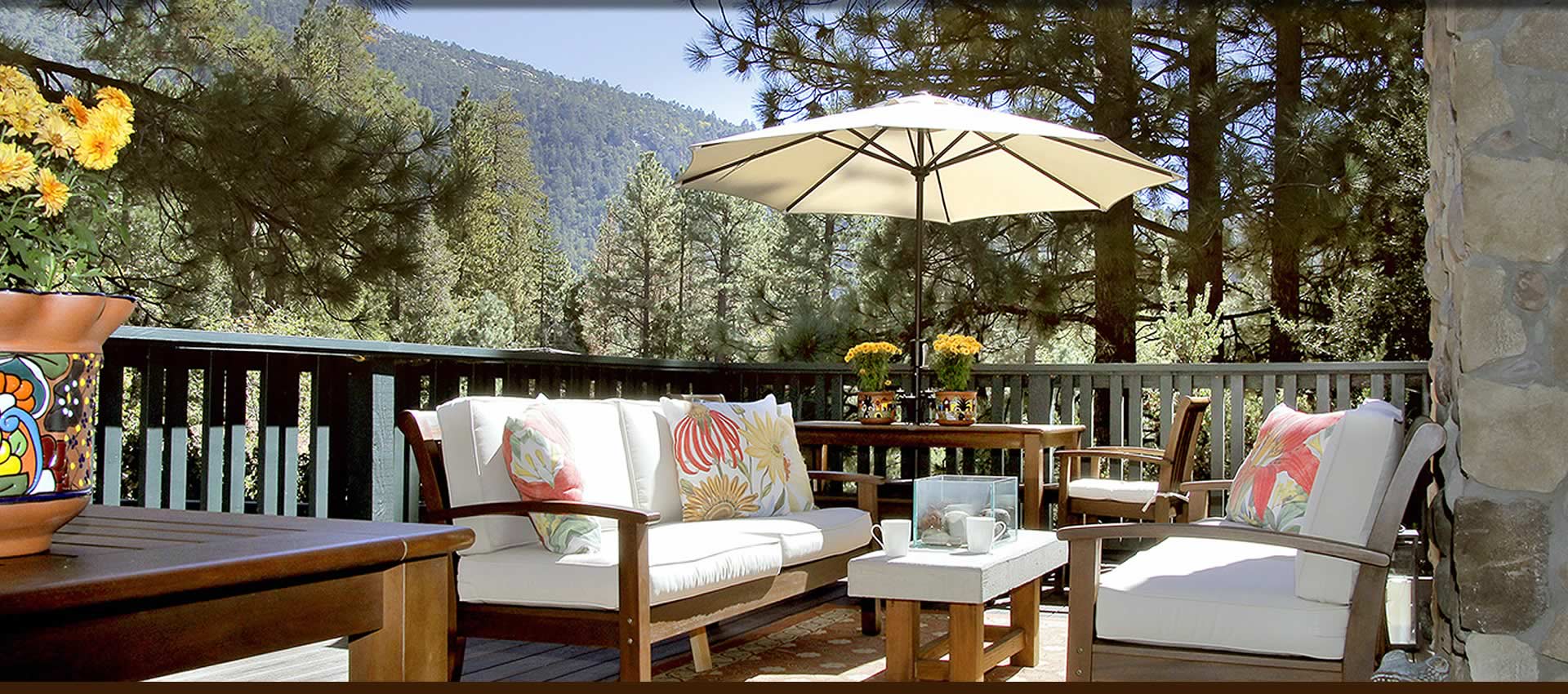 Grand Idyllwild deck sitting area with scenic mountain view