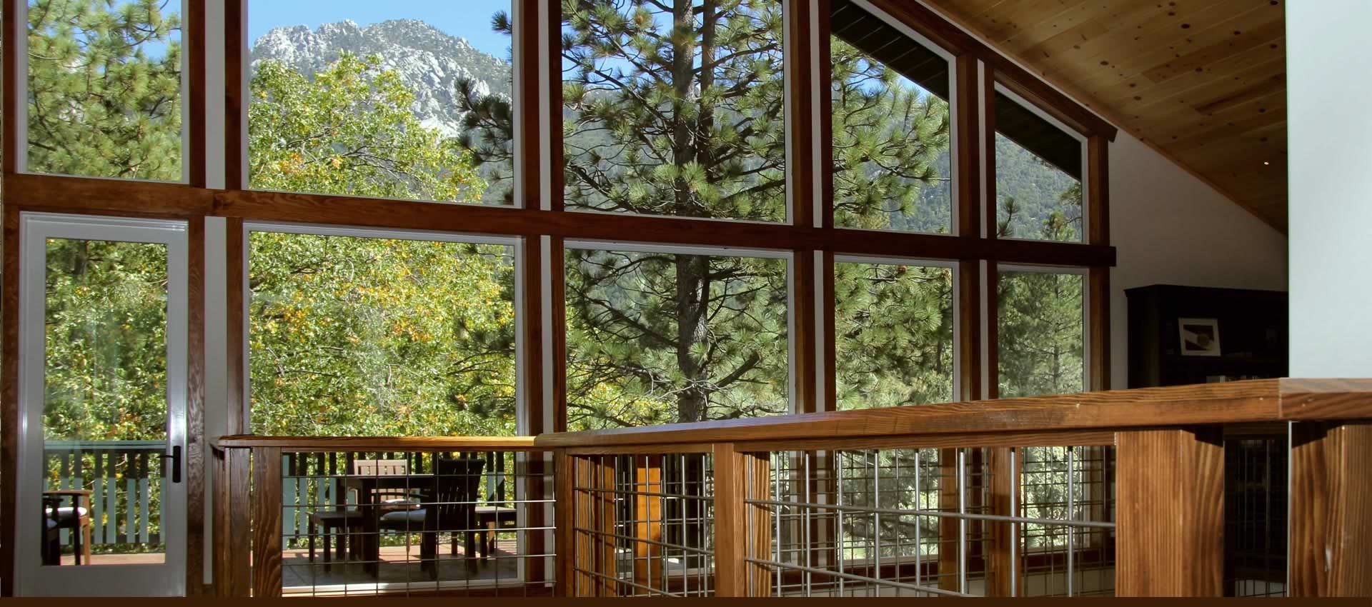 Grand Idyllwild Lodge large windows looking out to forest and mountains