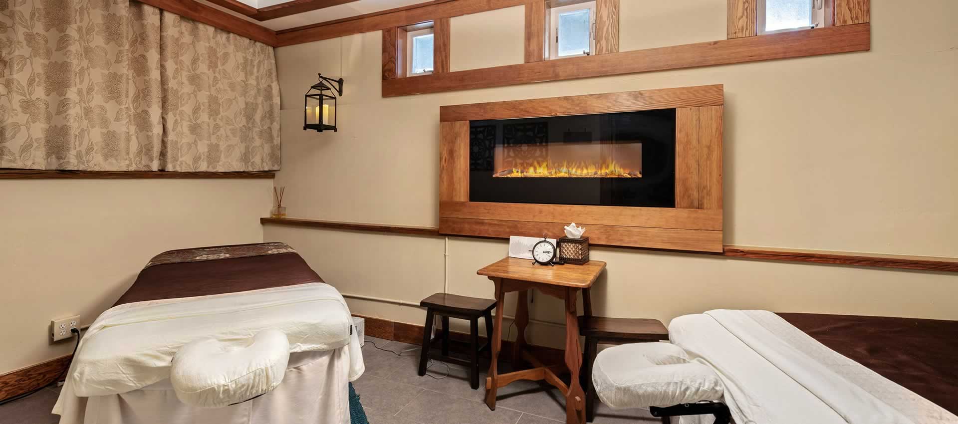 Grand Idyllwild Lodge massage tables and fireplace