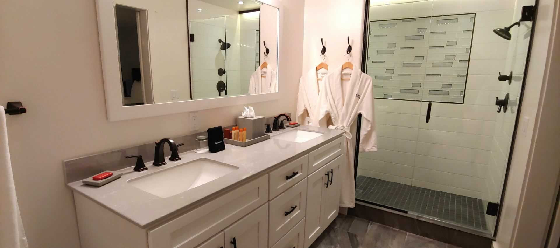 Suite Getaway Bathroom vanity with shower and robes