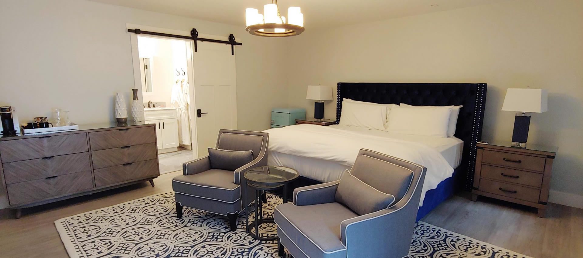 Suite Getaway bed with sitting area chairs