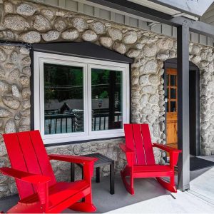 The Cottage at The Creekstone living room with a gas burning stove pipe stove.