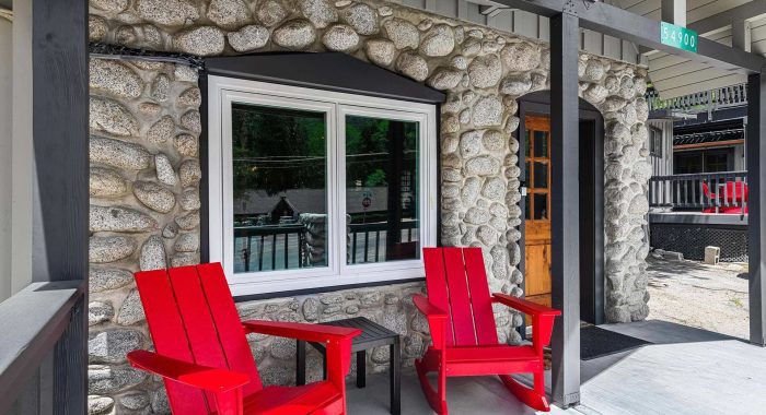 The Cottage at The Creekstone living room with a gas burning stove pipe stove.